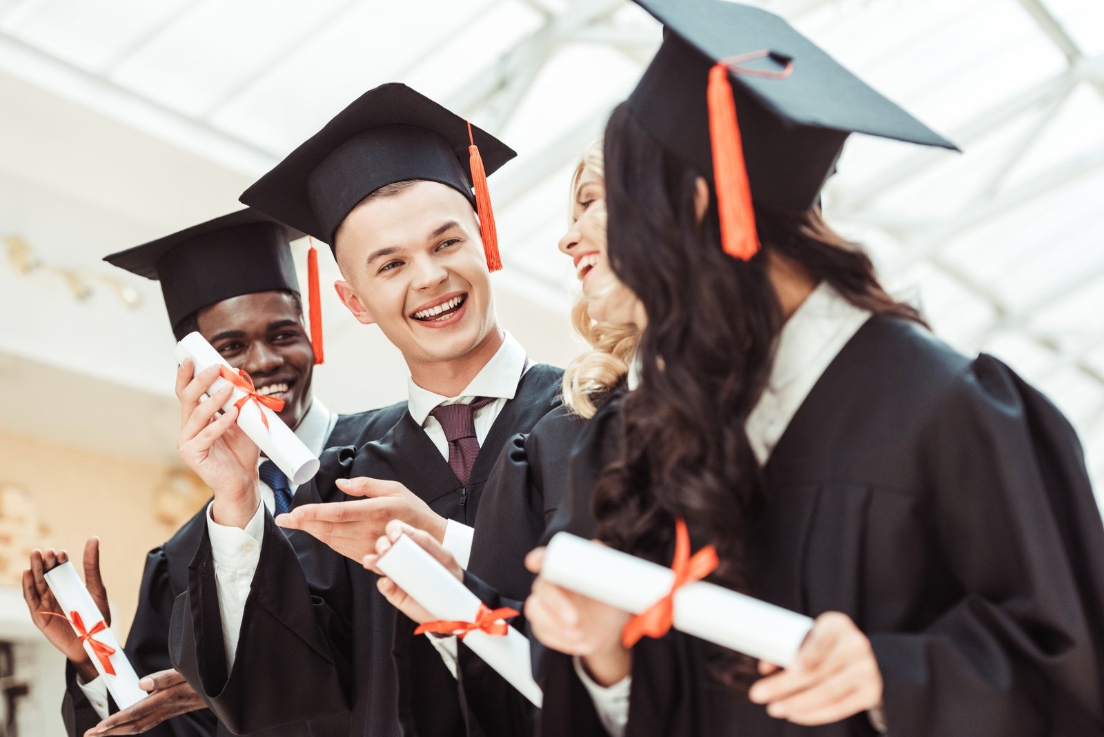 laughing-graduated-multiethnic-students-with-diplomas.jpg